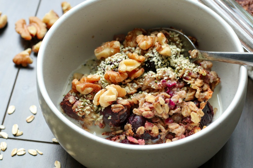 Bowl of baked oatmeal with blueberries, hemp hearts and walnuts